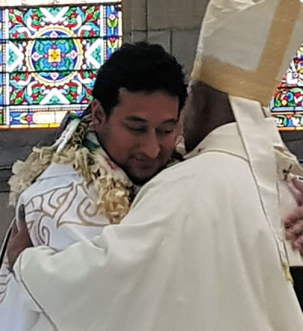 Fr. Pat embraced by Archbishop Peter Loy Chong