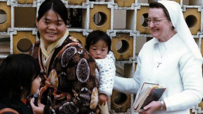 Sr. Damien with a mother and child at the Caritas Center in Fanling.