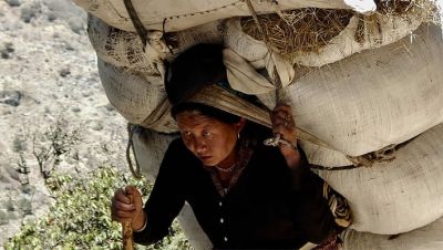 Woman carrying a heavy load