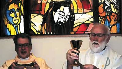 Columban Frs. Barry Cairns (right) and Leo Schumaker (left) in front of the window